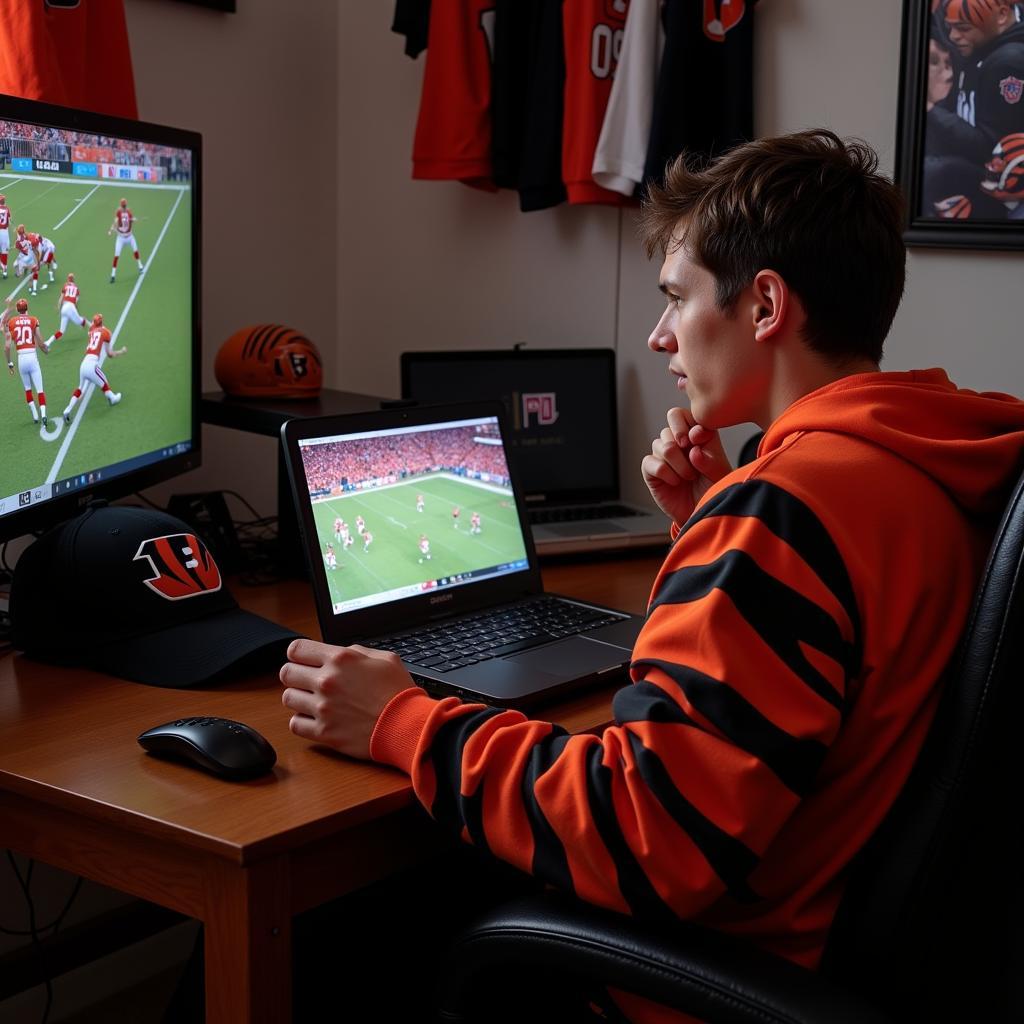 Bengals fan cheering while watching a live stream on their laptop