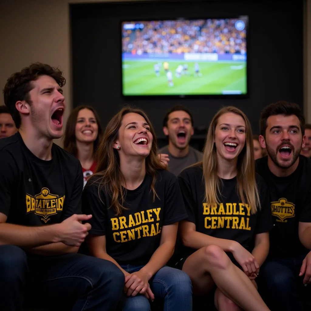 Group of fans enthusiastically watching a Bradley Central High School football game via live-stream