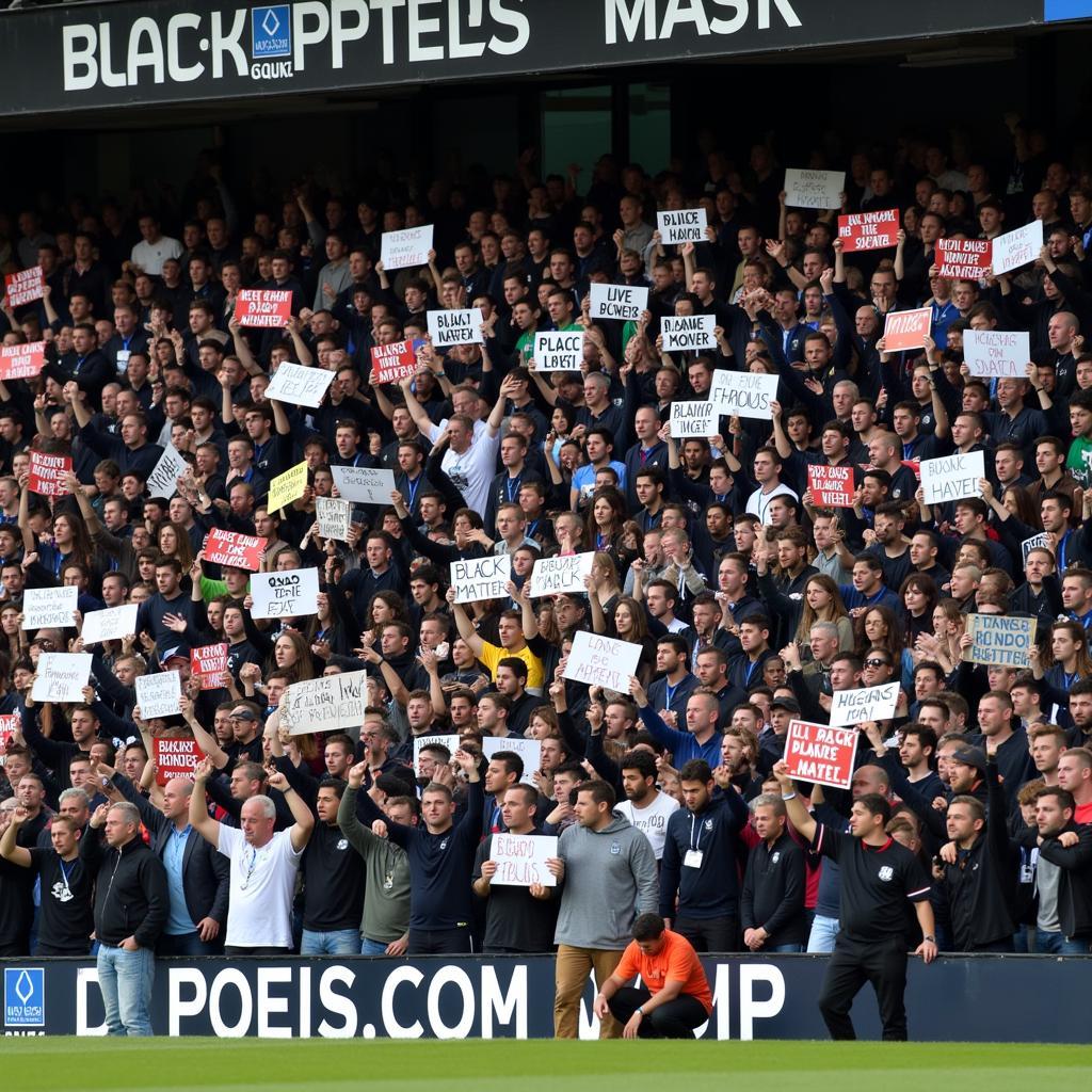 Football fans holding up Black Lives Matter signs