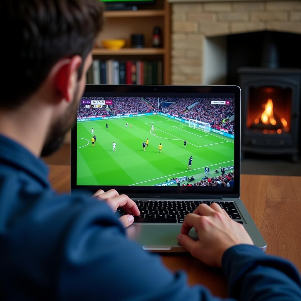 A person watching football on their laptop