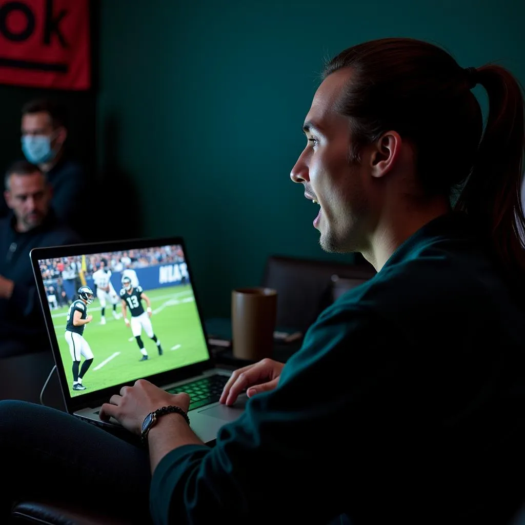 Fan watching football live stream Eagles on laptop