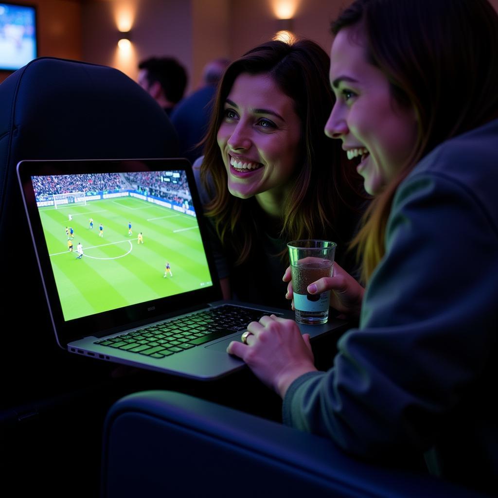 Fans watching football game live free on laptop