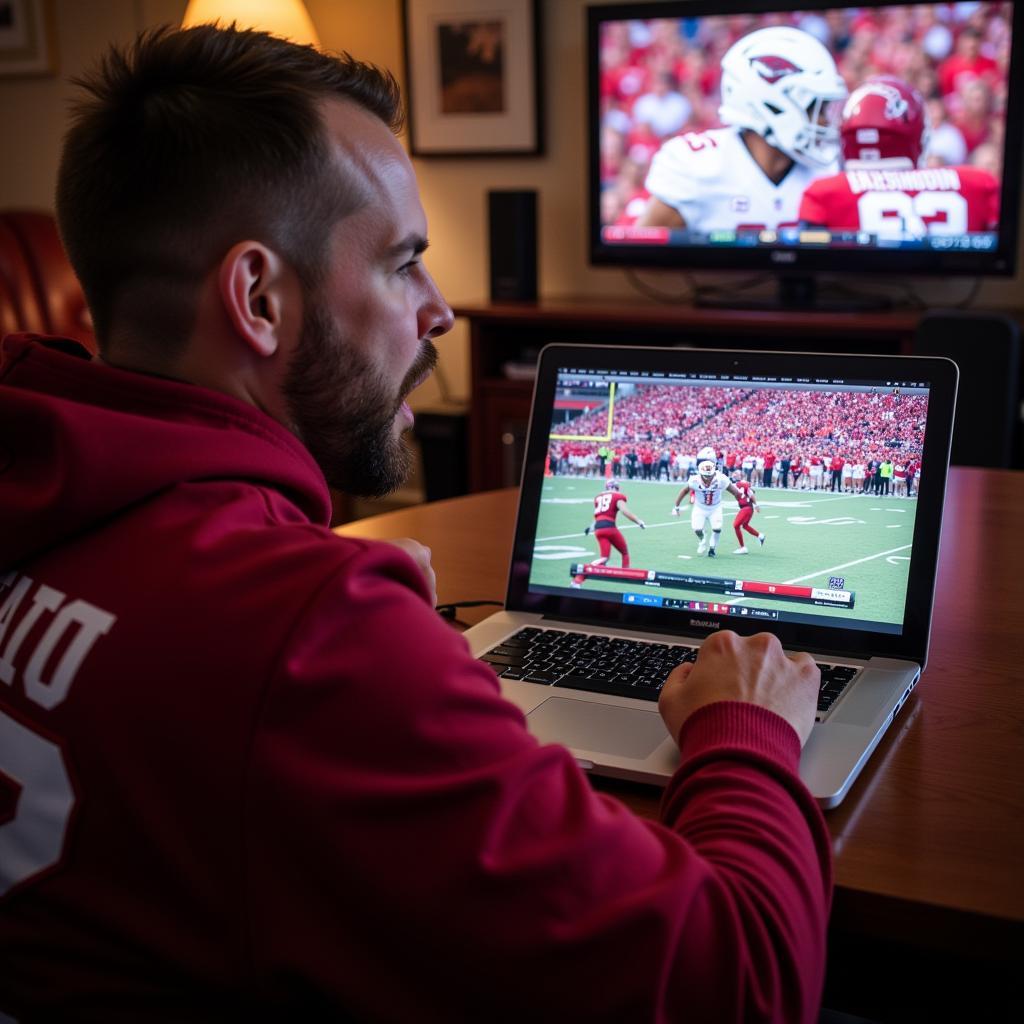 Arkansas Football Fan Watching Live Stream on Laptop