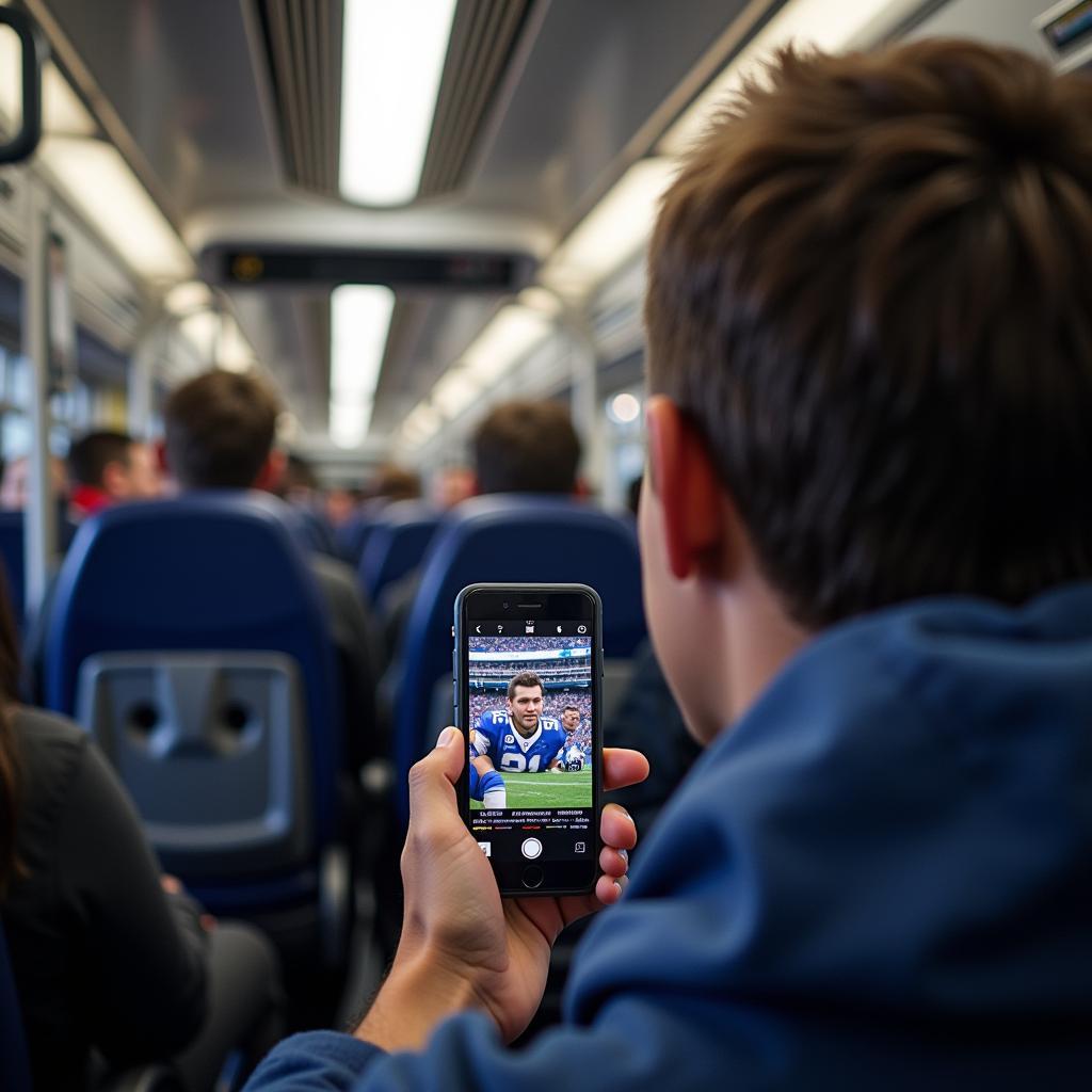 BYU Football Fan Watching Game on Phone