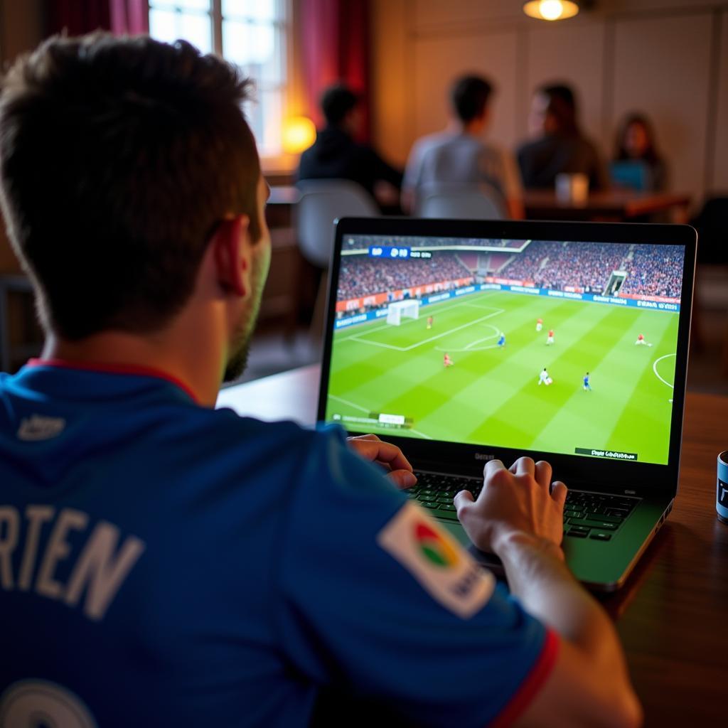 Fan Watching Football on Laptop