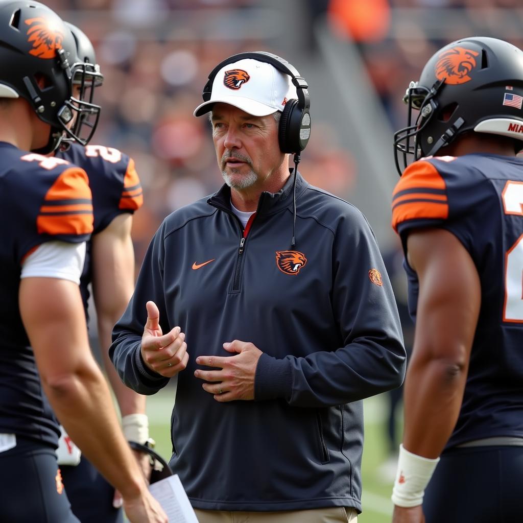 Oregon State Beavers football coach strategizing with players