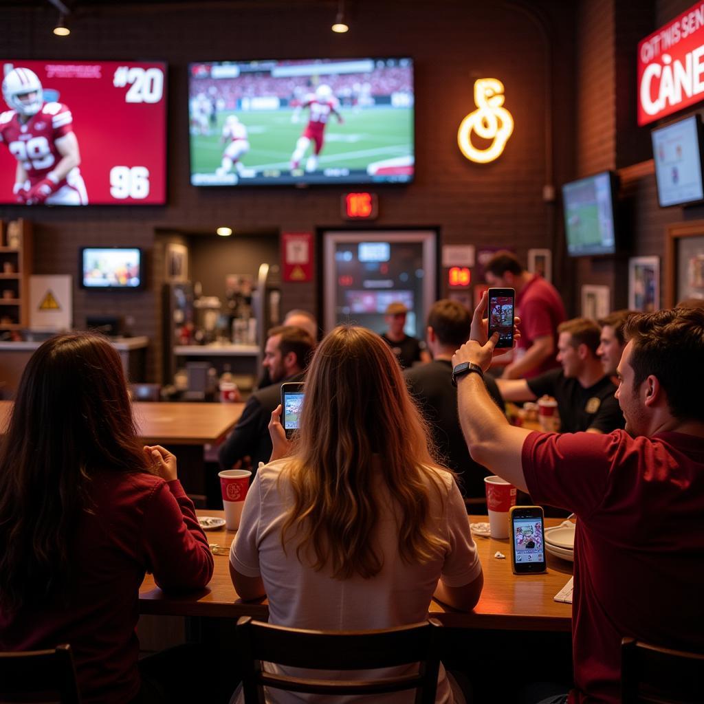 OU Football Fans Checking Live Scoreboard