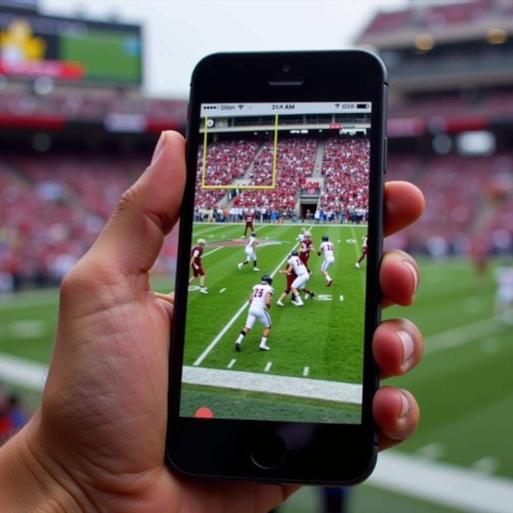 A fan watching Center Grove Football live stream on their phone