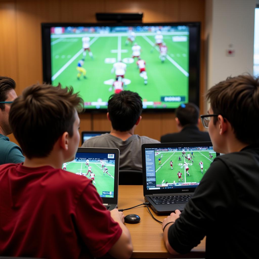 Students Watching Davison Football Live Stream on Laptops