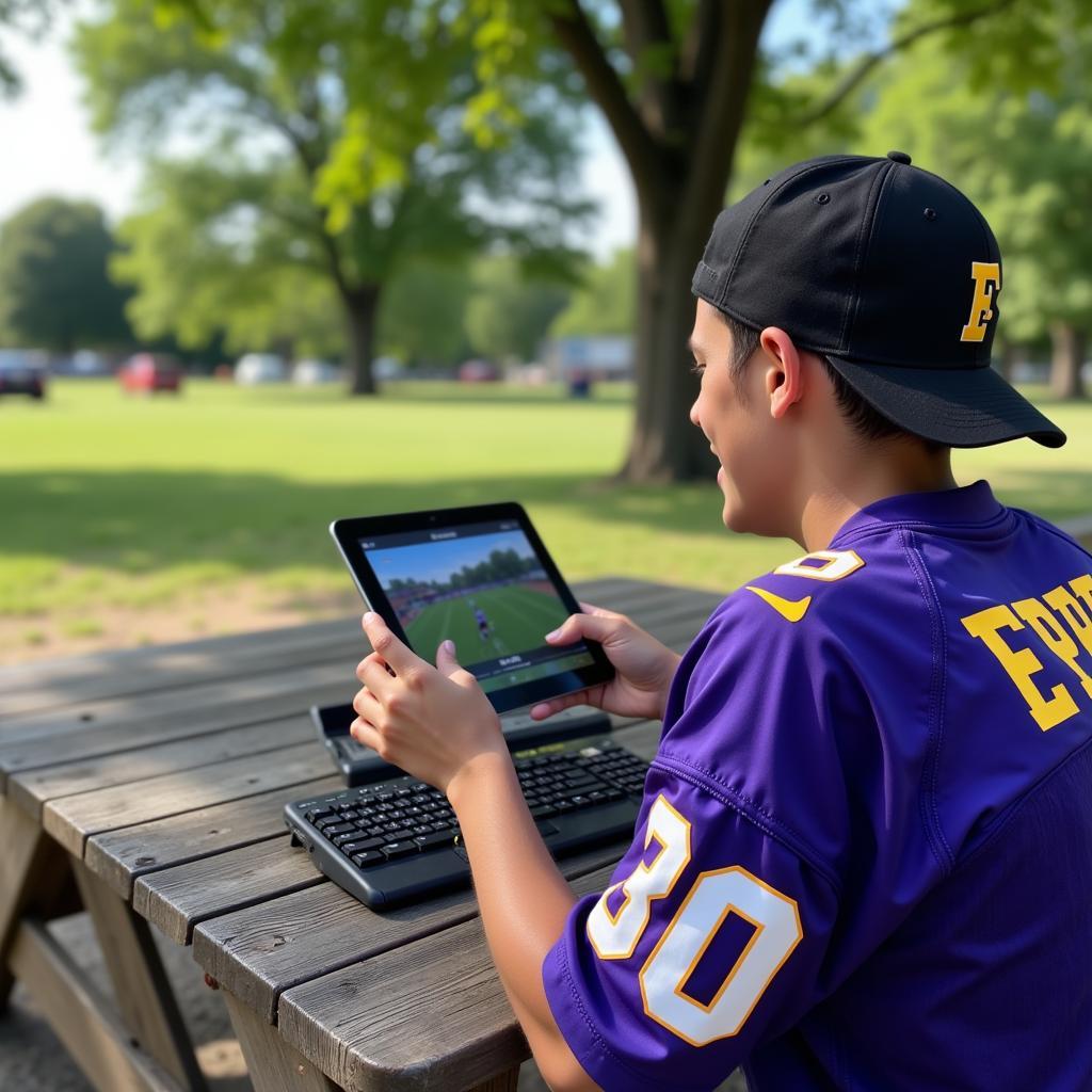 Ephrata Football Fan Watching Live Stream on Tablet Outdoors